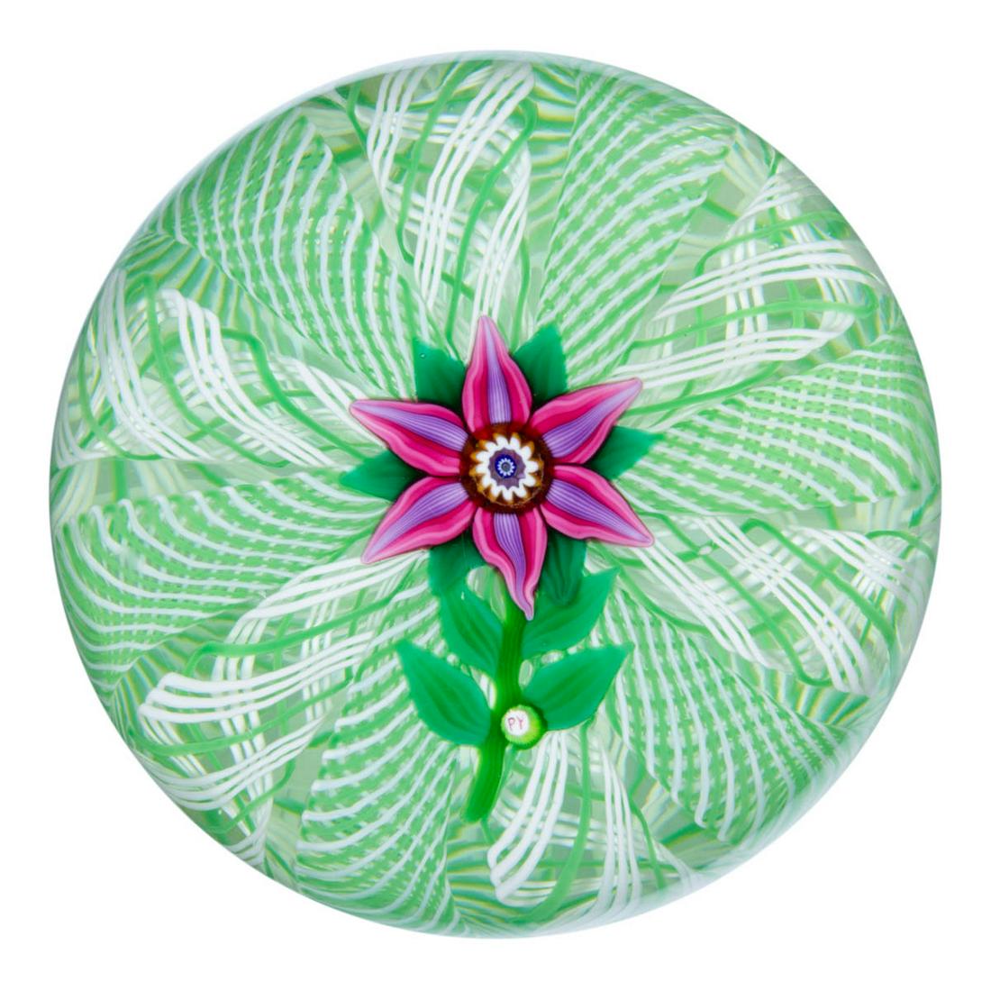 PAUL YSART (SCOTTISH, 1904-1979) SINGLE-FLOWER LAMPWORK: PAUL YSART (SCOTTISH, 1904-1979) SINGLE-FLOWER LAMPWORK ART GLASS PAPERWEIGHT, central fuchsia and purple six-petal flower with six green leaves protruding from the underside, having a short green ste