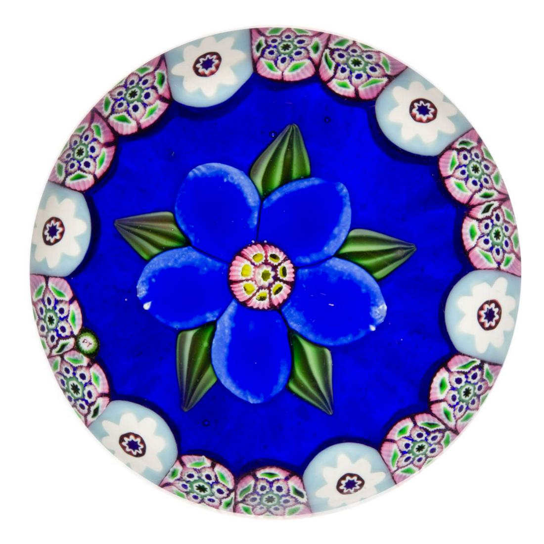 PAUL YSART (SCOTTISH, 1904-1979) FLORAL LAMPWORK AND: PAUL YSART (SCOTTISH, 1904-1979) FLORAL LAMPWORK AND MILLEFIORI ART GLASS MINIATURE PAPERWEIGHT, central blue five-petal flower with five ribbed green leaves protruding from the underside, encircled b