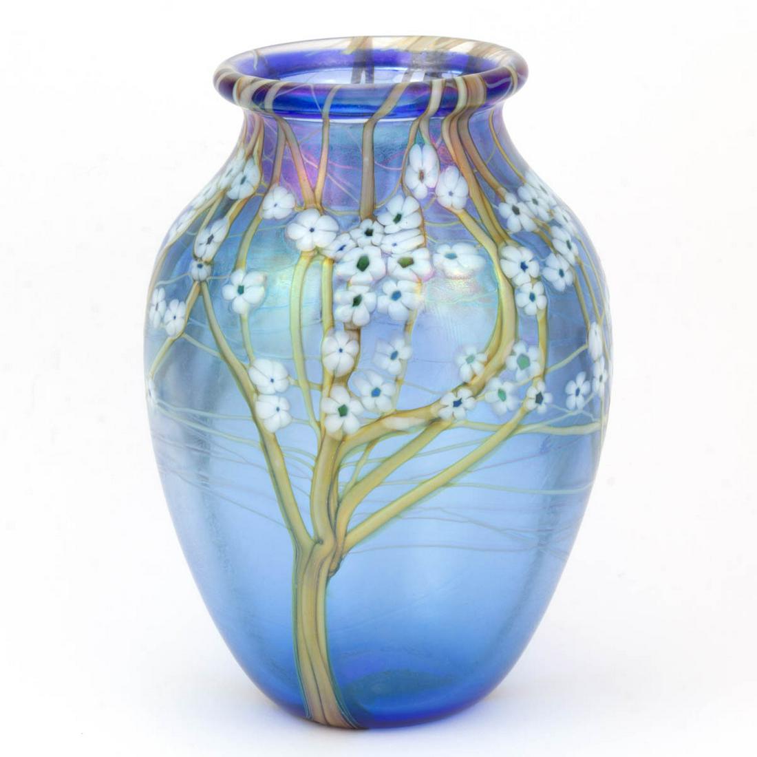 ORIENT & FLUME HAWTHORN MILLEFIORI AND IRIDESCENT: ORIENT & FLUME HAWTHORN MILLEFIORI AND IRIDESCENT STUDIO ART GLASS VASE, blue ground, variegated tan/brown trees and branches with many white millefiori floral cane blossoms in the trees, signed to th