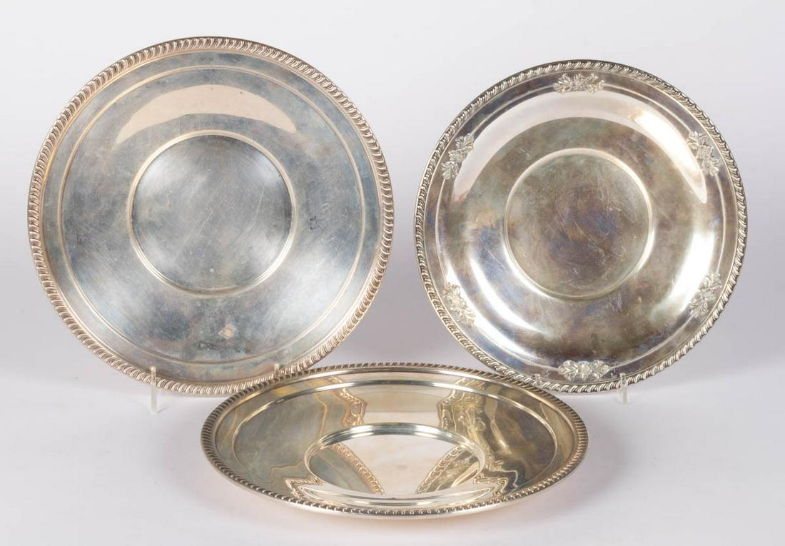 WALLACE AND OTHER STERLING SILVER SANDWICH PLATES, LOT: WALLACE AND OTHER STERLING SILVER SANDWICH PLATES, LOT OF THREE, each with a gadroon rim, comprising one by Wallace Silversmiths of Wallingford, CT with flower motif decoration, and a pair by Mueck-Ca