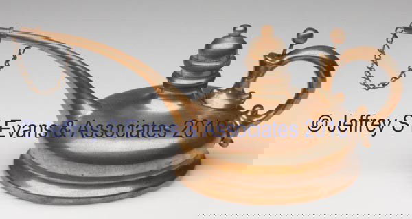 COPPER LAMP FILLER: COPPER LAMP FILLER, long spout with cap and chain, pump at scroll handle, marked "MANF'D BY THE BUFFALO MFG. CO. BUFFALO N.Y." 3 1/4" h overall, 3 3/4" dia base.Provenance: From the collection of Jo A