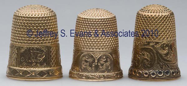 VARIOUS GOLD THIMBLES, LOT OF THREE: VARIOUS GOLD THIMBLES, LOT OF THREE, chased and engraved, consisting of a tested 14K scenic building over a diamond band example; a tested 10K; and a tested 12K with floral and scroll patterns. No mak