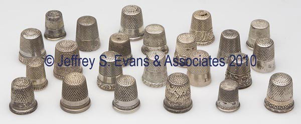 KETCHAM & MCDOUGALL STERLING SILVER THIMBLES, LOT O: KETCHAM & MCDOUGALL STERLING SILVER THIMBLES, LOT OF 23, various floral and scroll patterns including 11 with patterned rim edge. Each with maker's mark in apex, nine examples with monogram. Late 19th