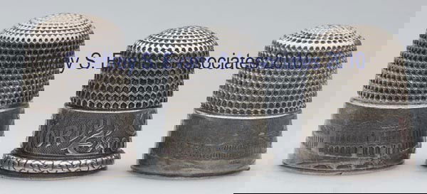 SIMONS BROTHERS STERLING SILVER "CHICAGO WORLD'S CO: SIMONS BROTHERS STERLING SILVER "CHICAGO WORLD'S COLUMBIAN EXPOSITION" THIMBLES, LOT OF THREE, consisting of two with plain rim and with views of buildings; and a scrolled rim example with cartouche.