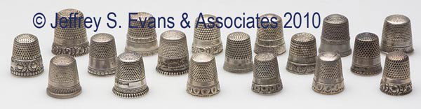 STERN BROS. STERLING SILVER THIMBLES, LOT OF 18: STERN BROS. STERLING SILVER THIMBLES, LOT OF 18, consisting of seven utilitarian and 11 with various chased and an embossed scroll patterns. Each with maker's anchor mark, three with monogram. Fourth 