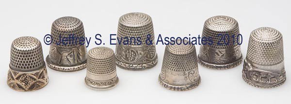 STERN BROS. AND GOLDSMITH, STERN & CO. STERLING SI: STERN BROS. AND GOLDSMITH, STERN & CO. STERLING SILVER THIMBLES, LOT OF SEVEN, consisting of three scenic landscape examples; a Bow, Ribbons, and Lilies-of-the-Valley; a grape band; a chased and engra