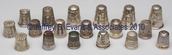 CONTEMPORARY ENGLISH SILVER THIMBLES, LOT OF 18: CONTEMPORARY ENGLISH SILVER THIMBLES, LOT OF 18, assorted makers, various patterns and souvenirs, one example with multi-color stone cap and another with a green stone cap. 20th century. Various sizes