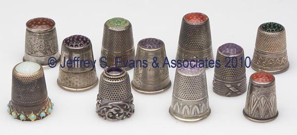 STERLING SILVER AND SILVER-LIKE WITH STONE CAPS TH: STERLING SILVER AND SILVER-LIKE WITH STONE CAPS THIMBLES, LOT OF 11, consisting of an applied band example with 13 turquoise colored stones and a pale green cap; a scrolled rim example with amethyst c