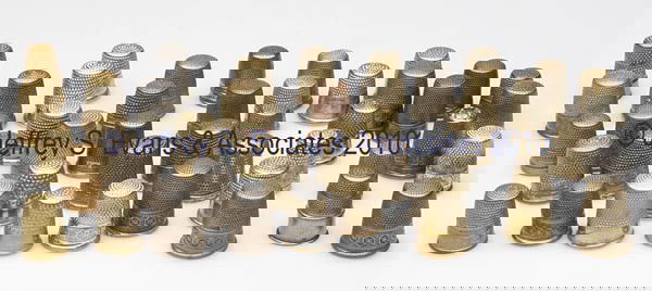 CONTINENTAL BRASS AND METAL THIMBLES, LOT OF 45: CONTINENTAL BRASS AND METAL THIMBLES, LOT OF 45, various utilitarian patterns, consisting of 18 English; 15 Austrian; and 12 German including one with a colorless stone cap. Late 19th to mid 20th cent