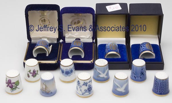 DENMARK BING & GRONDAHL PORCELAIN THIMBLES, LOT OF: DENMARK BING & GRONDAHL PORCELAIN THIMBLES, LOT OF 13, consisting of six Christmas dated examples; two with a white bird; two floral; a Blue Traditional; an Empire; and a ship scene. Each with maker's