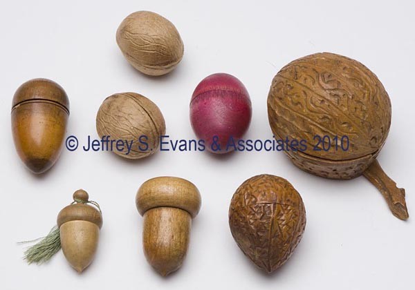 WOODEN FIGURAL THIMBLE CASES, LOT OF EIGHT: WOODEN FIGURAL THIMBLE CASES, LOT OF EIGHT, consisting of six various nuts including two acorns, along with two egg-form examples including one with later pink paint. Late 19th/early 20th century. 1 1