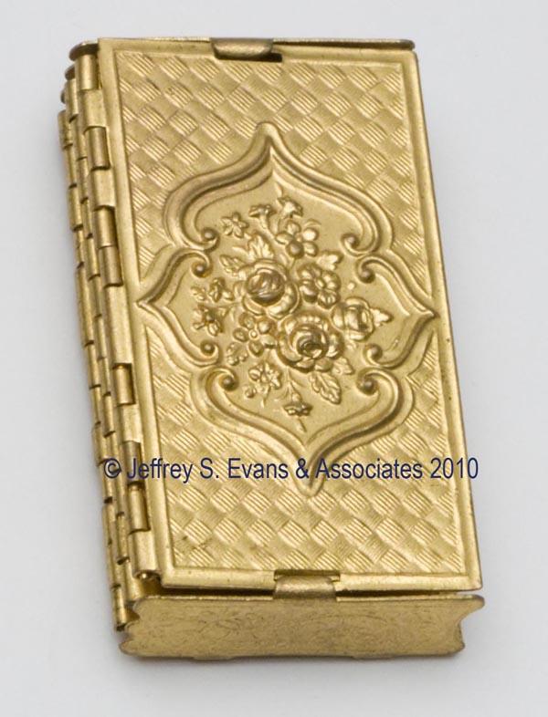 WILLIAM LEWIS "BEATRICE" ACCORDION BRASS NEEDLE CA: WILLIAM LEWIS "BEATRICE" ACCORDION BRASS NEEDLE CASE, folding screen-form embossed with cartouches of flowers, four sections to hold needle packets, each section stamped with needle sizes six thru nin