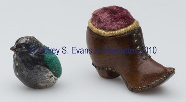 FIGURAL PIN CUSHIONS, LOT OF TWO: FIGURAL PIN CUSHIONS, LOT OF TWO, consisting of a wooden boot with brass rivets and pink velvet cushion; and a sterling silver chick with unidentified hallmarks and "AN" in a shield. Late 19th/early 2