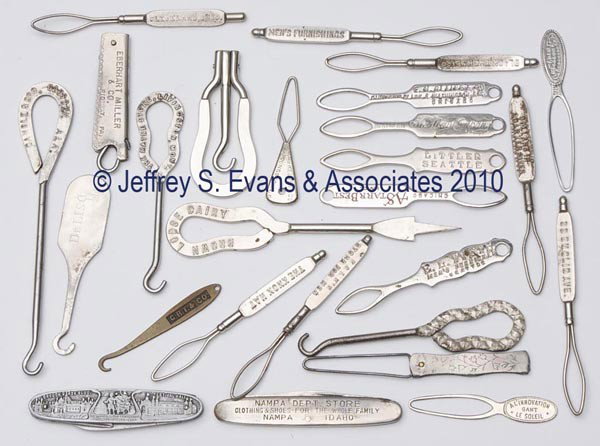 VARIOUS METAL ADVERTISING BUTTON HOOKS AND KNIVES,: VARIOUS METAL ADVERTISING BUTTON HOOKS AND KNIVES, LOT OF 26, consisting of 23 button hooks including 15 closed-loop and three folding; two knives including one with the 1905 Lewis & Clark Centennial 