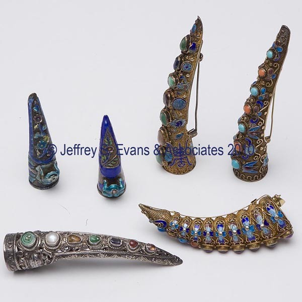 ORIENTAL ENAMELED FINGER / NAIL GUARDS, LOT OF SIX: ORIENTAL ENAMELED FINGER / NAIL GUARDS, LOT OF SIX, consisting of four examples each impressed "SILVER" on the back and with cabochon insets, one example with embossed urns and floral decoration and t