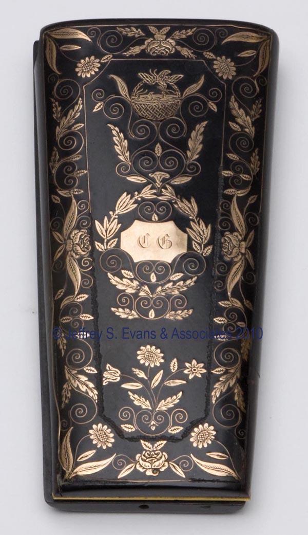 LACQUER WITH GOLD PICQUE' SEWING CASE: LACQUER WITH GOLD PICQUE' SEWING CASE, entwining wreath and floral pattern with monogram, interior fitted with red velvet lining, needleworking tools include a bodkin and a thimble. Late 19th/early 20