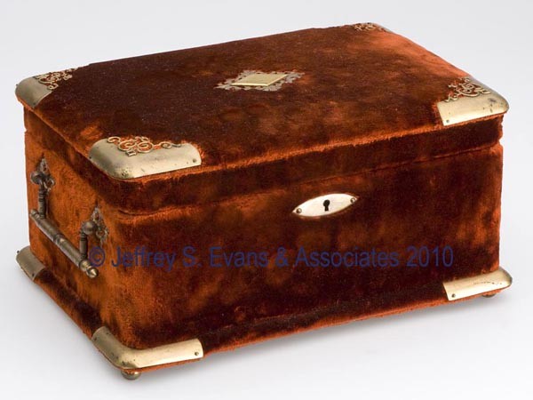 VELVET AND BRASS MOUNTED SEWING BOX: VELVET AND BRASS MOUNTED SEWING BOX, orange velvet with brass corners, handles and ball feet, hinged lid with interior mirror, fitted with brown silk lining, lift-out tray with two compartments and fi
