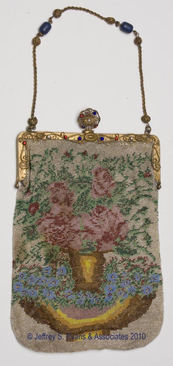 VINTAGE LADY'S BEADED PURSE: VINTAGE LADY'S BEADED PURSE, gold-tone metal frame with applied scrolls, faux jewels, and ornate clasp, polychrome floral design, original chain, lacking most of lining. First half 20th century. 10' x