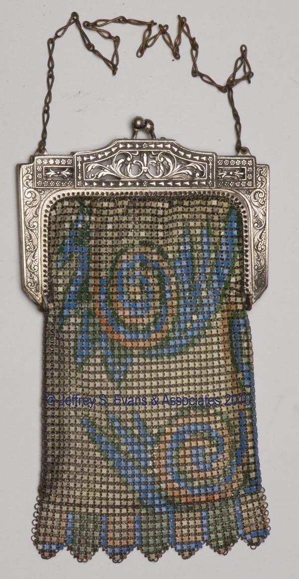 WHITING & DAVIS LADY'S MESH PURSE: WHITING & DAVIS LADY'S MESH PURSE, polychrome enamel decoration, elaborate reticulated silver-plate frame, unlined, with two maker's tags, original chain. First half 20th century. 3 3/4" x 6 1/2".