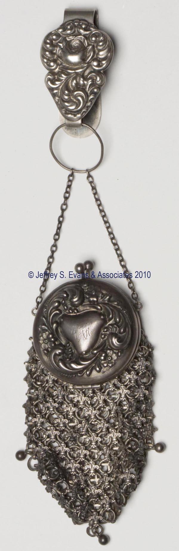 WHITING & DAVIS STERLING SILVER LADY'S MESH PURSE: WHITING & DAVIS STERLING SILVER LADY'S MESH PURSE, compact style with hinged top above a chain-link and fleur-di-lys bag, marked sterling and W&D, with chain, loop, and plated-silver chatelaine clip. 
