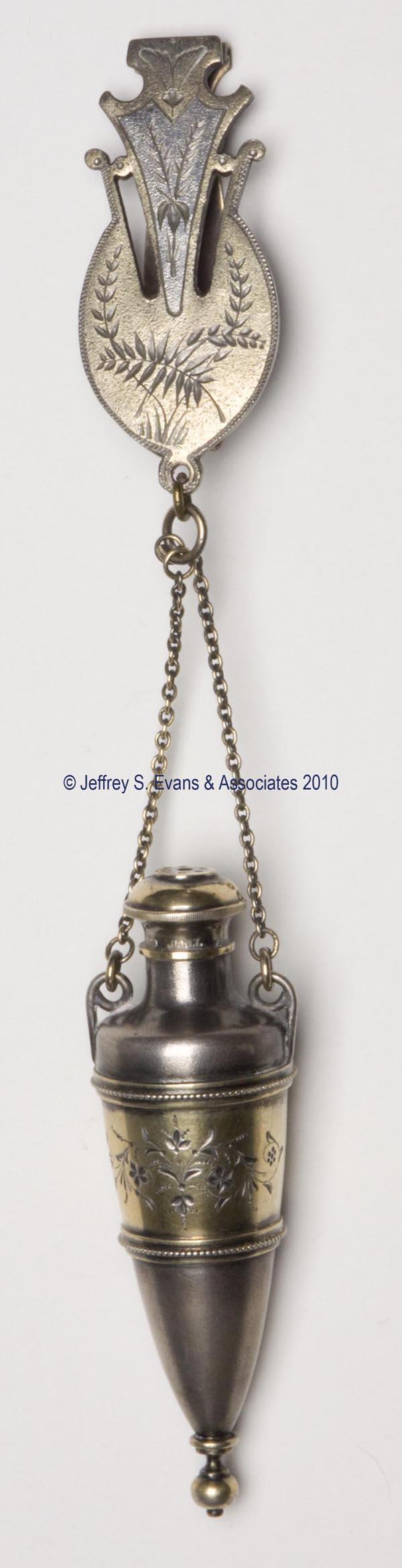 VICTORIAN QUADRUPLE-PLATE SCENT BOTTLE: VICTORIAN QUADRUPLE-PLATE SCENT BOTTLE, classical urn-form with gold-washed and engraved decorations, sprinkler cap with patent information, original chain and chatelaine clip. Fourth quarter 19th cen