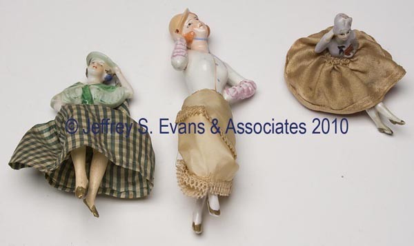 THREE ASSORTED CHINA FLAPPER HALF DOLLS: THREE ASSORTED CHINA FLAPPER HALF DOLLS, each fitted with legs and clothing of unknown association, marked Germany and Japan. First half 20th century. 3" to 8" h. Provenance: Hilda Fried estate, New Y