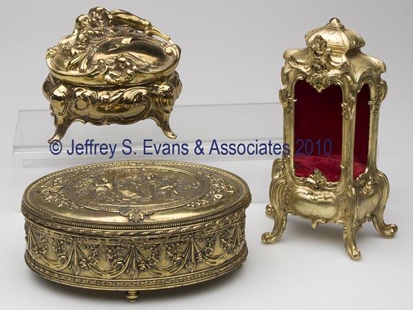 THREE GILT-METAL DRESSER BOXES: THREE GILT-METAL DRESSER BOXES, including Art Nouveau, Rococo, and Neo-Classical styles, each with plush interior. 20th century. 3 1/4" to 8 1/2" h. Provenance: Hilda Fried estate, New York City.