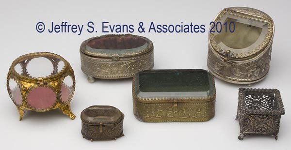 SIX ASSORTED METAL AND GLASS JEWEL BOXES: SIX ASSORTED METAL AND GLASS JEWEL BOXES, four with beveled glass, each with fabric interior, smallest engraved Chicago on top. Late 19th/early 20th century. 1 1/4" to 3" h. Provenance: Hilda Fried es