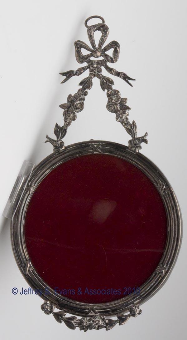 BLACK, STARR & FROST STERLING SILVER HANGING PHOTO: BLACK, STARR & FROST STERLING SILVER HANGING PHOTO FRAME, Neo-Classical style with a hinged swag hanger, fully hallmarked. Late 19th/early 20th century.7 3/4" h overall, 4 1/4" dia picture. Provenance
