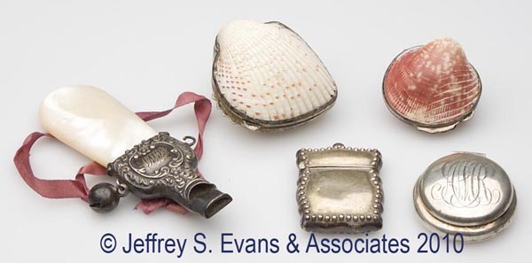 FIVE ASSORTED SILVER OBJETS DE VIRTUE: FIVE ASSORTED SILVER OBJETS DE VIRTUE, comprised of a mother-of-pearl handled baby rattle/whistle, a pill box, and a stamp case, each marked sterling, along with two seashells with hinged sterling mou