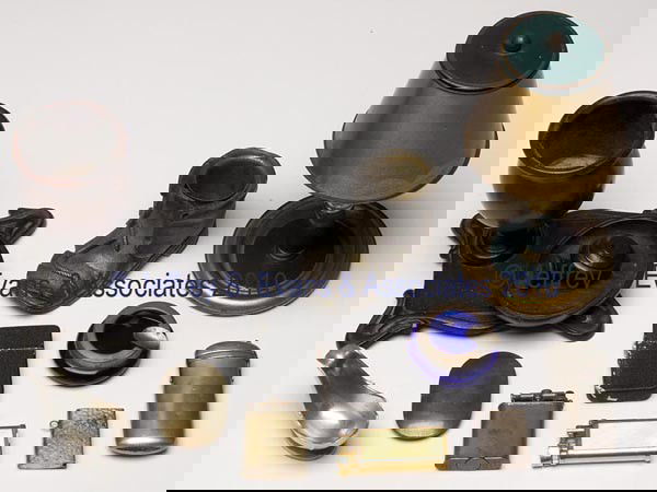 ELEVEN ASSORTED METALS SMOKING ACCESSORIES: ELEVEN ASSORTED METALS SMOKING ACCESSORIES, including Dunhill and Nasco lift-arm lighters, a lamp-form cigarette dispenser, a shoe-form match holder, and a wood and iron smoking set. 20th century. Lar