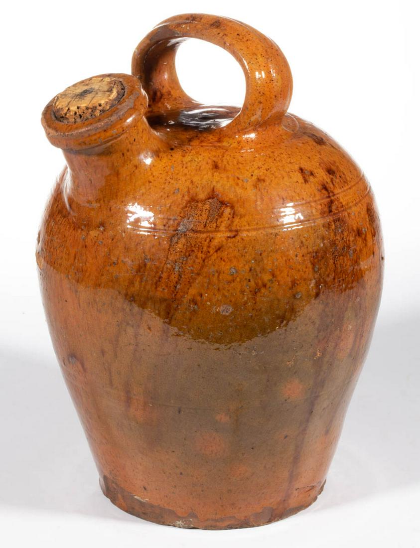 MID-ATLANTIC EARTHENWARE / REDWARE HARVEST JUG: MID-ATLANTIC EARTHENWARE / REDWARE HARVEST JUG, lead-glazed with manganese splotches, approximately one-gallon capacity, tapered form with spaced incised ring decorations including two to shoulder and