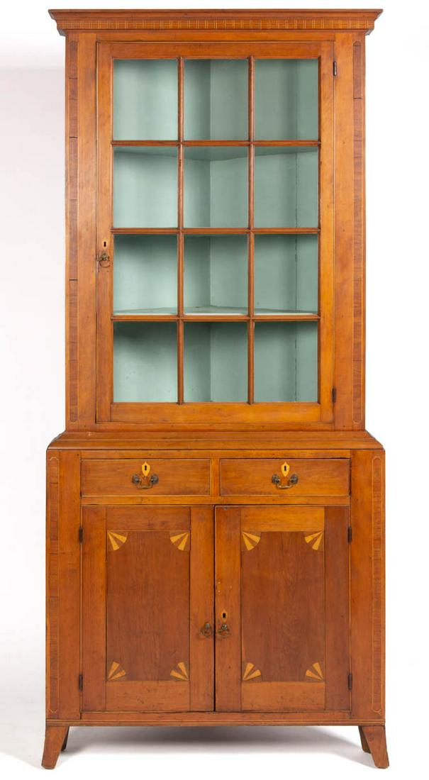 SOUTHERN FEDERAL INLAID CHERRY CORNER CUPBOARD: SOUTHERN FEDERAL INLAID CHERRY CORNER CUPBOARD, two-piece construction, squared returns, the upper section with applied cove-molded cornice and complex line-inlaid frieze in a stylized dentil pattern 