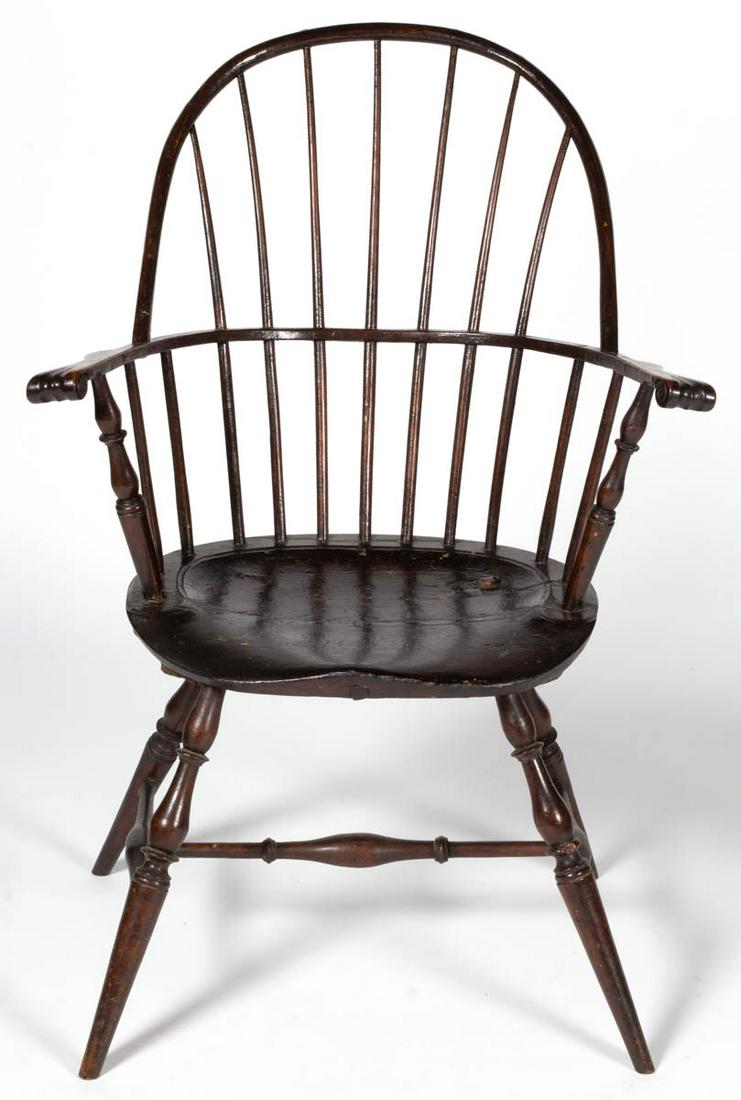 PHILADELPHIA, PENNSYLVANIA SACK-BACK WINDSOR ARMCHAIR: PHILADELPHIA, PENNSYLVANIA SACK-BACK WINDSOR ARMCHAIR, seven-spindle back, shaped arms with finely carved knuckles, and saddle seat, raised on widely splayed bulbous-turned legs joined with an H-form 