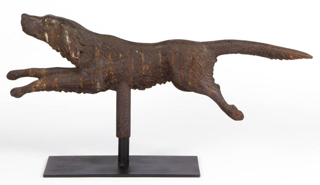 AMERICAN FOLK ART FULL-BODY CAST-IRON SETTER / BIRD DOG: AMERICAN FOLK ART FULL-BODY CAST-IRON SETTER / BIRD DOG WEATHERVANE, running position, made in two joined sections with hollow mounting post. Old weathered surface. Presented on a custom iron stand. L