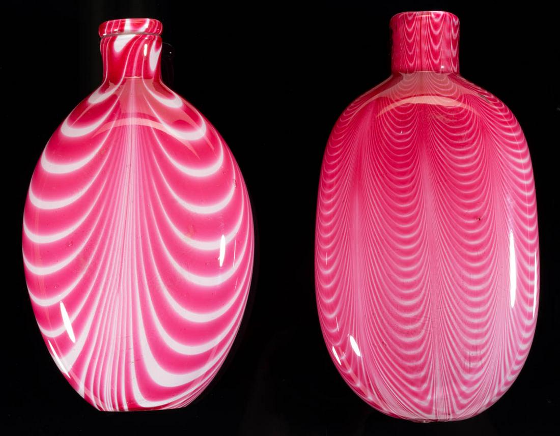MARBRIE-DECORATED FLASKS, LOT OF TWO: MARBRIE-DECORATED FLASKS, LOT OF TWO, opal with groupings of cranberry loopings, all cased colorless, comprising a compressed ovoid form and a rectangular form, one having a factory-polished base. Uni