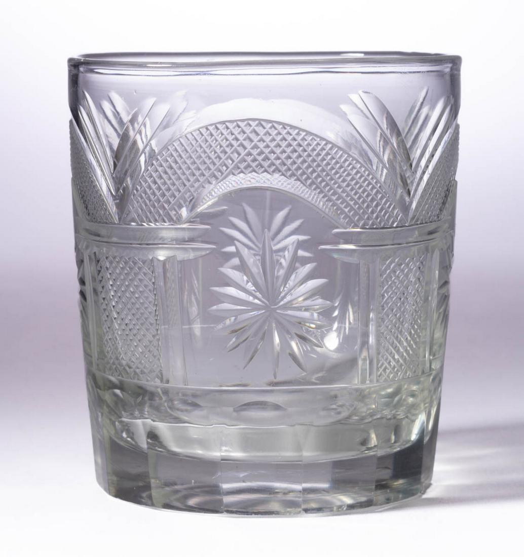 CUT MASONIC TUMBLER: CUT MASONIC TUMBLER, colorless lead glass, cylindrical form cut with Masonic pillars connected by corresponding arches, each framing a 12-point star, above the panel-cut base, polished pontil mark. Pi