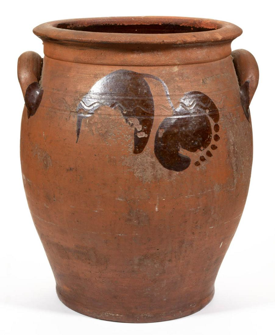 STAMPED "JOHN W. BELL" WAYNESBORO, PENNSYLVANIA: STAMPED "JOHN W. BELL" WAYNESBORO, PENNSYLVANIA DECORATED EARTHENWARE / REDWARE JAR, lead-glazed interior and unglazed exterior, approximately two-gallon capacity, ovoid form with an incised sine wave