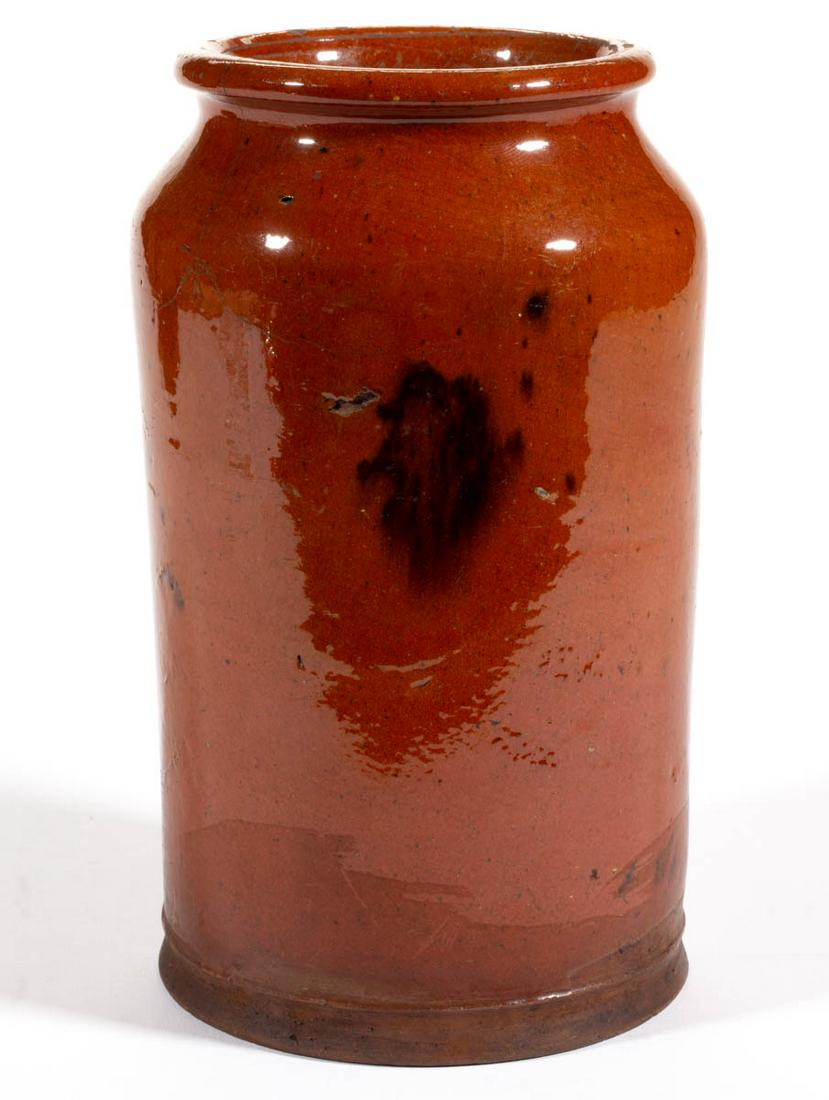 NEW ENGLAND DECORATED EARTHENWARE / REDWARE JAR: NEW ENGLAND DECORATED EARTHENWARE / REDWARE JAR, lead-glazed with single manganese splotch, approximately one-quart capacity, cylindrical from with sharp shoulder and flanged, tie-off rim, raised on a