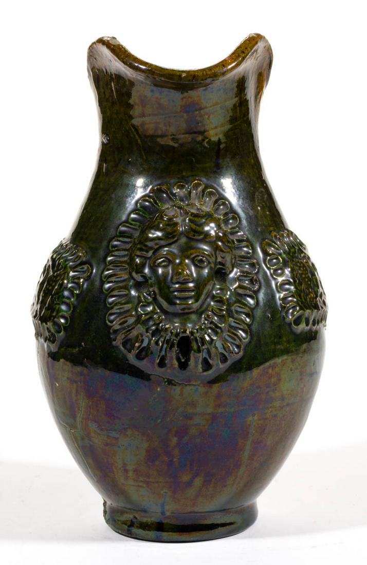 AMERICAN SPRIG-MOLDED PATRIOTIC EARTHENWARE / REDWARE: AMERICAN SPRIG-MOLDED PATRIOTIC EARTHENWARE / REDWARE PITCHER, copper- and lead-glazed, ovoid form with medial-ridge handle having a triple-fingerprint lower terminal, raised on a pronounced foot. Dec