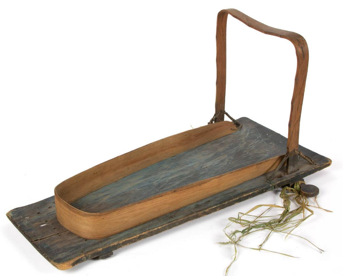 NATIVE AMERICAN PAINTED WOOD CRADLE BOARD / TIKINAGAN: NATIVE AMERICAN PAINTED WOOD CRADLE BOARD / TIKINAGAN, shaped plank board retaining original blue-painted surface with shaped batten to upper back and chamfered batten to lower back, applied bentwood 