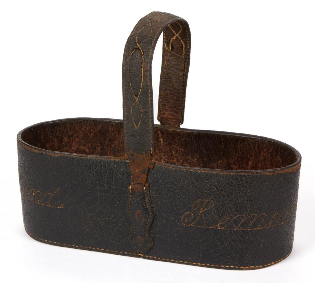 EXTREMELY RARE VIRGINIA DECORATED AND INSCRIBED LEATHER: EXTREMELY RARE VIRGINIA DECORATED AND INSCRIBED LEATHER KEY BASKET, oblong form with even rim and arched handle having shaped terminals, very unusual stitched script "To a Friend" and "Remember Me" to