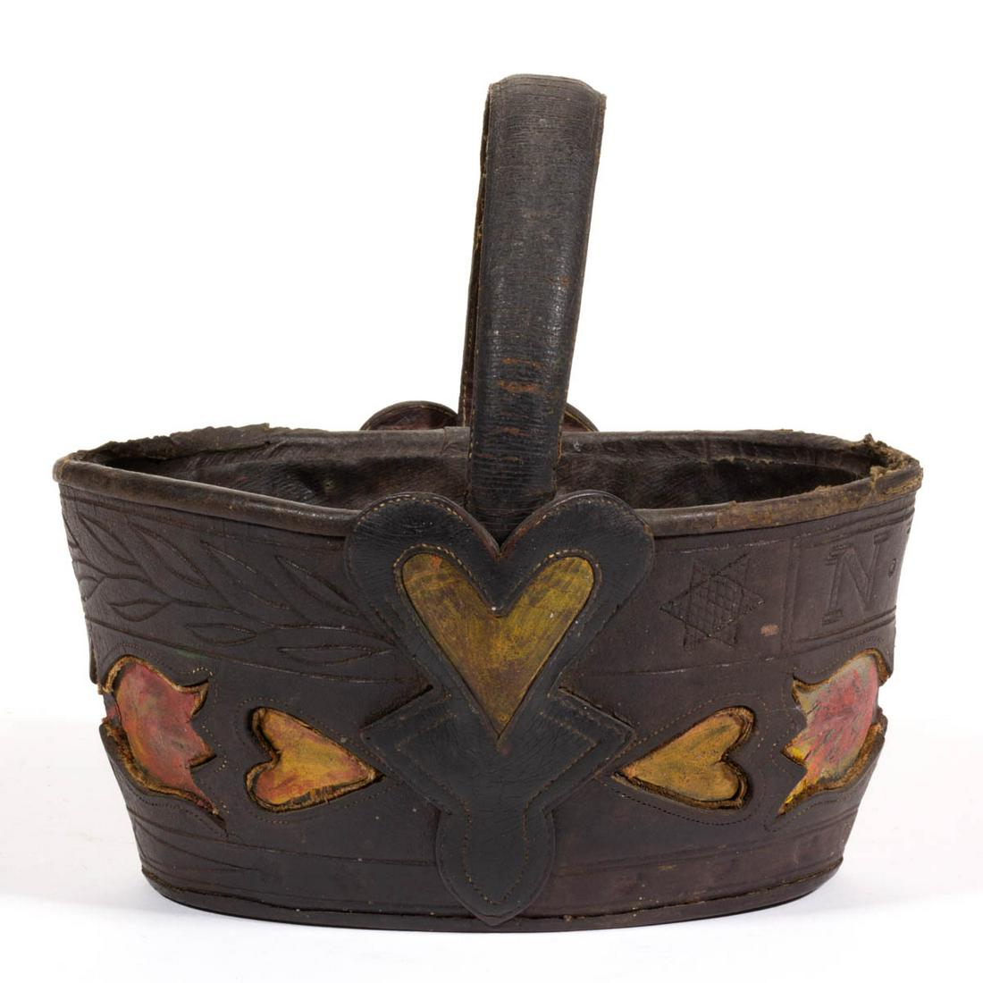 EXTREMELY RARE RICHMOND, VIRGINIA AREA TOOLED AND: EXTREMELY RARE RICHMOND, VIRGINIA AREA TOOLED AND CUT-OUT LEATHER KEY BASKET, oval form with a band of cut-out hearts and tulips outlined with stitching to lower half of body at each end, one end havi