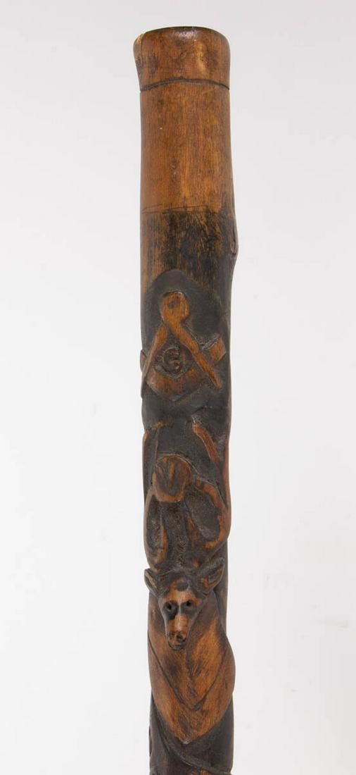 VIRGINIA AFRICAN-AMERICAN FRATERNAL CARVED FOLK ART: VIRGINIA AFRICAN-AMERICAN FRATERNAL CARVED FOLK ART CANE / WALKING STICK, featuring a Masonic compass and square, stage head with "V" for Virginia, "IBPOE of W", hand with sleeve, and alligator. Retai