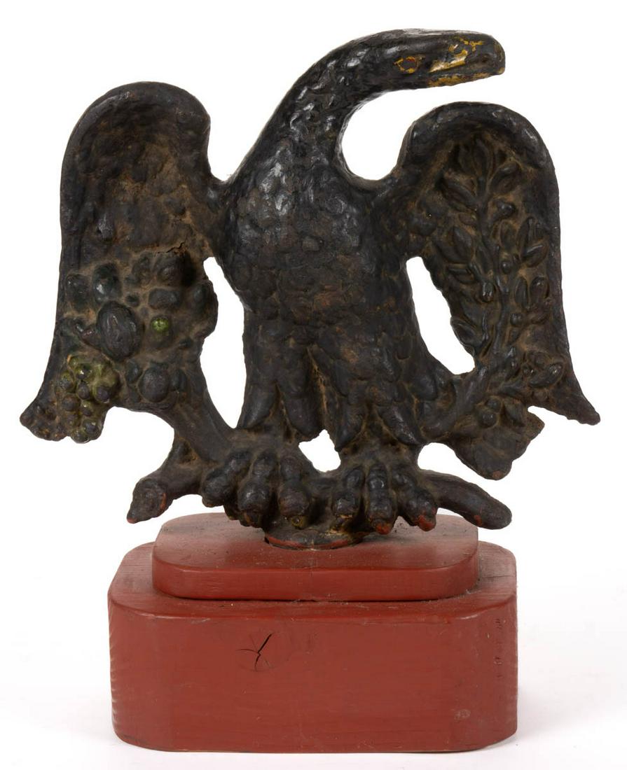 AMERICAN FOLK ART CAST-IRON FIGURAL PRINTING PRESS: AMERICAN FOLK ART CAST-IRON FIGURAL PRINTING PRESS WEIGHT, depicting a spread-wing eagle clutching a branch and flowers, applied to a later red-painted base. Old black-painted surface, with traces of