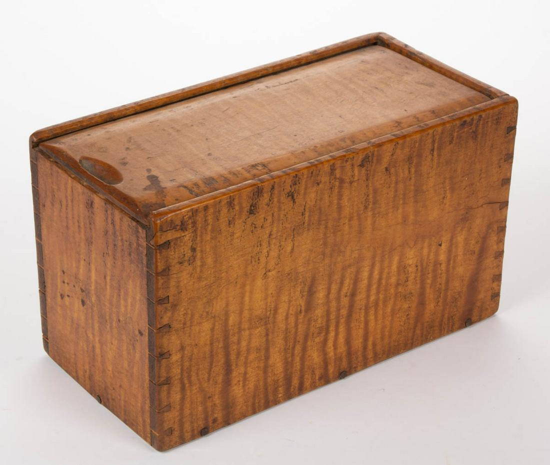 OHIO / WEST VIRGINIA TIGER MAPLE CANDLE BOX: OHIO / WEST VIRGINIA TIGER MAPLE CANDLE BOX, finely dovetailed, deep rectangular form with chamfered-edge sliding lid having a carved finger slot, inset poplar bottom attached with cut nails. Very goo