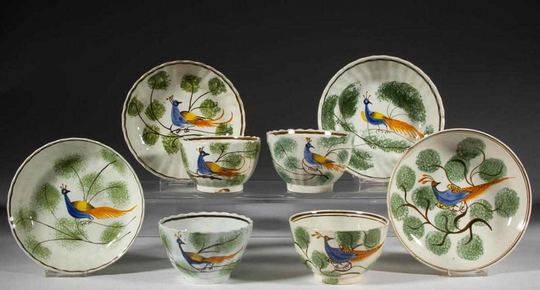ENGLISH PEARLWARE PEAFOWL CERAMIC CUP AND SAUCER SETS,: ENGLISH PEARLWARE PEAFOWL CERAMIC CUP AND SAUCER SETS, LOT OF FOUR, each featuring polychrome hand-painted exotic bird perched on a green-sponged branch, comprising three scalloped rim examples with "