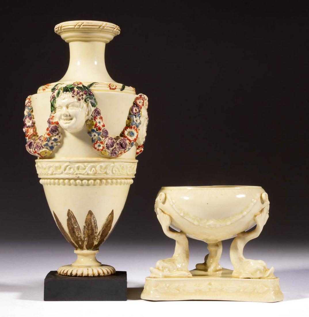 ENGLISH CREAMWARE CERAMIC ARTICLES, LOT OF TWO: ENGLISH CREAMWARE CERAMIC ARTICLES, LOT OF TWO, comprising a bolted urn featuring applied masks and floral swag decoration with bold polychrome enamel decoration, gilt-painted foliate leaves to bottom