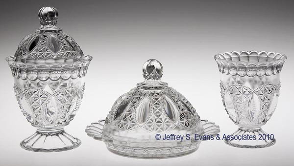 BEADED LOOP THREE-PIECE TABLE SET: BEADED LOOP THREE-PIECE TABLE SET, colorless, consisting of a butter dish, covered sugar and spooner. 5" to 7 3/4" h overall. Provenance: From the estate of Olive Alder.