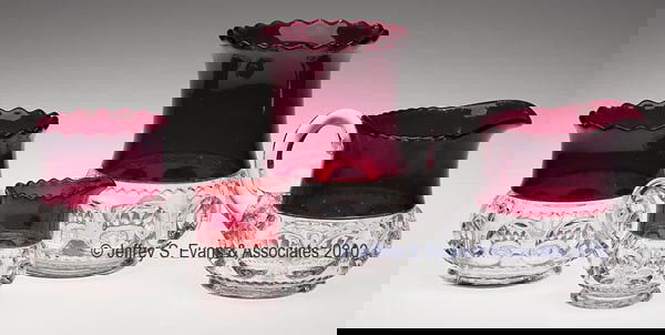 KING'S CROWN - RUBY STAINED TABLE ARTICLES, LOT OF: KING'S CROWN - RUBY STAINED TABLE ARTICLES, LOT OF FOUR, colorless, consisting of a celery vase, table and individual creamers, and spooner. 3" to 6" h.Provenance: Collection of Stephen H. Chapman.
